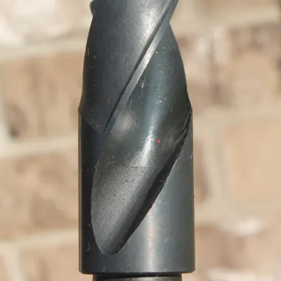 Sale Photo Thumbnail #10: Black oxide high-speed steel drill bit attachment showing spiral flutes and cutting tip in clean, usable condition.