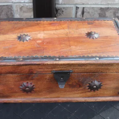 Sale Photo Thumbnail #68: Rustic wooden keepsake chest featuring wrought iron corner braces, starburst studs, and a front latch.