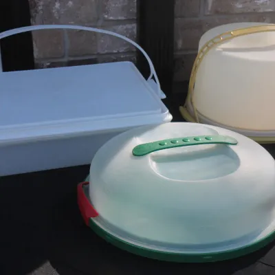 Sale Photo Thumbnail #35: Trio of vintage plastic cake and pie carriers, including a rectangular Tupperware container and two round covered carriers with handles.