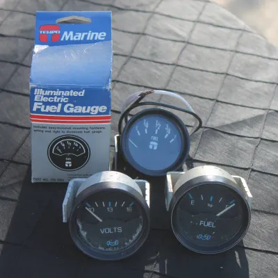 Sale Photo Thumbnail #29: Collection of marine gauges including Tempo illuminated electric fuel gauges and a voltmeter, complete with original retail packaging.