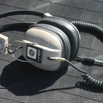Sale Photo Thumbnail #41: Vintage General Electric model H-22 stereo headphones with a coiled cord and 1/4-inch audio jack, made in Japan.