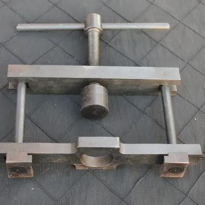 Sale Photo Thumbnail #23: Heavy-duty steel adjustable flaring tool or specialized vise, featuring a center screw handle and side thumb screws.