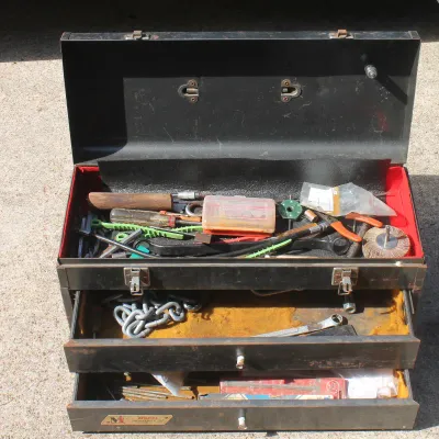 Sale Photo Thumbnail #69: Vintage Model Industries black metal tool chest with two drawers and a top compartment filled with assorted hand tools and hardware.