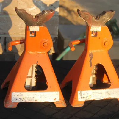 Sale Photo Thumbnail #22: Pair of orange 3-ton ratchet automotive jack stands showing light wear from use.