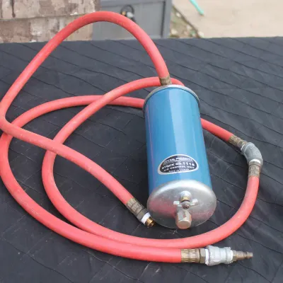 Sale Photo Thumbnail #52: Central Pneumatic air control unit stock no. 1118 with an attached red rubber air hose.