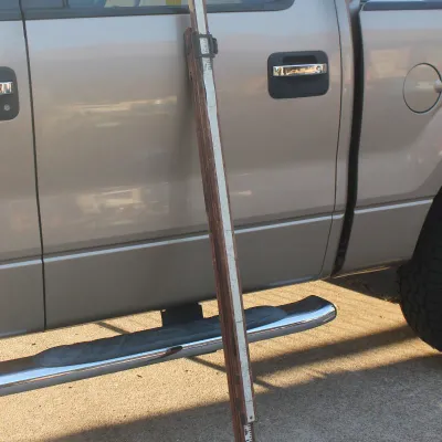 Sale Photo Thumbnail #18: Vintage wooden surveyor's leveling rod leaning against a pickup truck, featuring printed measurements and brass hardware.