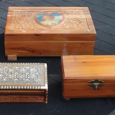 Sale Photo Thumbnail #67: Trio of vintage decorative wooden keepsake boxes, including a pin-up girl cedar chest, a mother-of-pearl inlaid marquetry jewelry box, and a footed wooden chest.