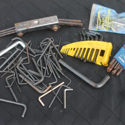 Sale Photo Thumbnail #54: Large assortment of loose and cased Allen hex keys in various metric and SAE sizes, showing light to moderate surface rust and wear.