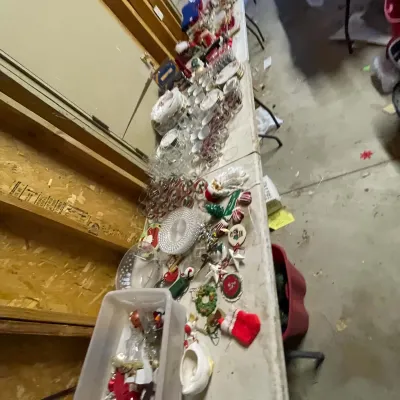 Sale Photo Thumbnail #7: Folding tables packed with vintage Christmas decor, glassware, dishes, ornaments, and holiday trinkets.
