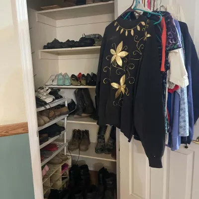 Sale Photo Thumbnail #82: Walk-in closet filled with vintage women's clothing hanging on hangers and shelves organized with various footwear including boots, heels, and casual shoes.