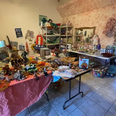 Sale Photo Thumbnail #47: Collection of assorted holiday and seasonal decorations, plush figures, household goods, and small kitchenware displayed on folding tables.