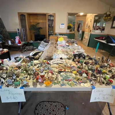 Sale Photo Thumbnail #64: Large collection of small ceramic, resin, and decorative figurines displayed on a folding table.