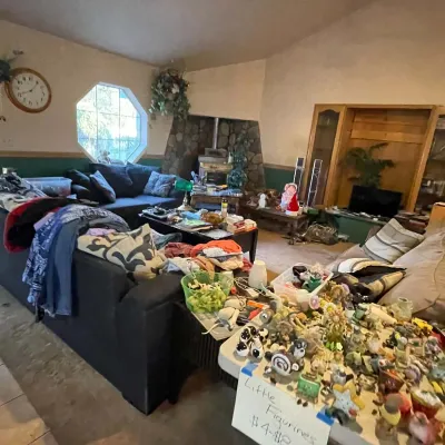 Sale Photo Thumbnail #63: Living room setup filled with items including upholstered sofas, small decorative figurines displayed on a table, and home decor pieces.