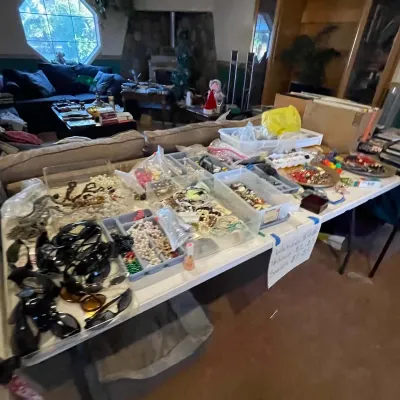 Sale Photo Thumbnail #65: Folding table display filled with assorted vintage fashion jewelry, sunglasses, and small accessories sorted into trays and bins.