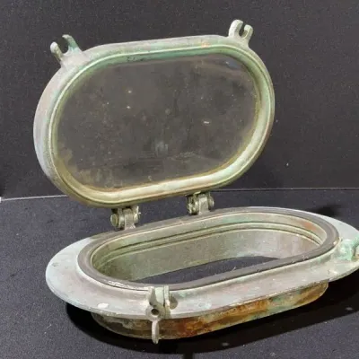 Sale Photo Thumbnail #45: Vintage heavy brass or bronze oval ship's porthole with hinged glass window and heavy verdigris patina.
