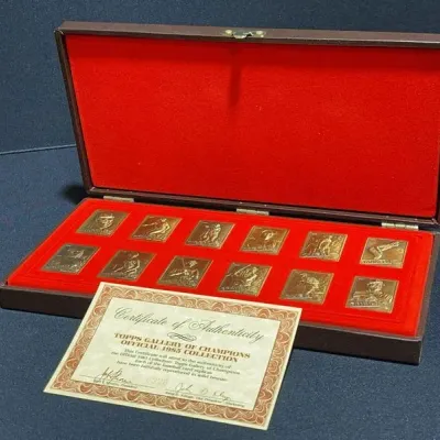 Sale Photo Thumbnail #57: Topps Gallery of Champions Official 1985 Collection set featuring twelve bronze baseball card replicas in a red felt-lined presentation case with Certificate of Authenticity.