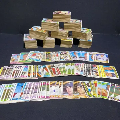 Sale Photo Thumbnail #77: Large collection of vintage 1960s Topps baseball cards, including stacked piles and organized rows featuring various player cards.