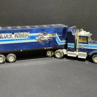 Sale Photo Thumbnail #78: Vintage Nylint Silver Knight Express semi-truck and trailer toy, showing light play wear and intact knight graphics.