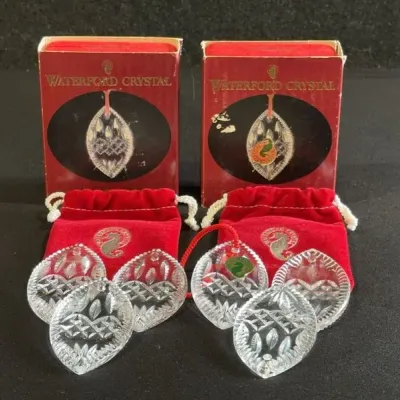 Sale Photo Thumbnail #93: Set of six Waterford crystal leaf-shaped Christmas ornaments, complete with red velvet drawstring pouches and original boxes.