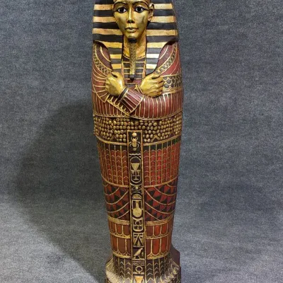 Sale Photo Thumbnail #7: Ornate Egyptian King Tut sarcophagus cabinet statue, decorated with gold leaf accents and detailed hieroglyphics.
