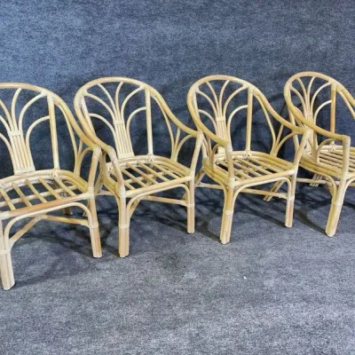 Sale Photo Thumbnail #35: Set of four light-finish bentwood rattan armchairs featuring fan-back details, circa late 20th century.