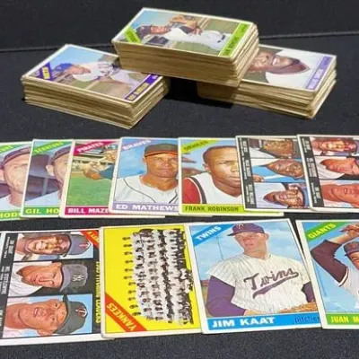 Sale Photo Thumbnail #55: Collection of vintage Topps baseball cards from the 1960s, including stacks and displayed individual cards featuring star players like Frank Robinson, Ed Mathews, and Juan Marichal.