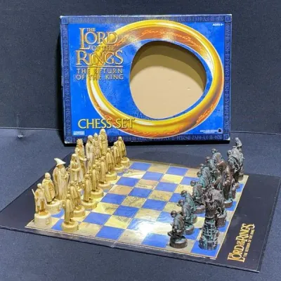 Sale Photo Thumbnail #47: The Lord of the Rings: The Return of the King themed chess set with character pieces, folding board, and original outer box.