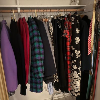 Sale Photo Thumbnail #59: Closet filled with vintage women's clothing, including coats, dresses, jackets, and accessories hanging on a wooden rod.