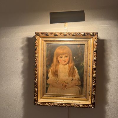 Sale Photo Thumbnail #47: Antique framed portrait of a young girl with long reddish-blond hair in a white dress, housed in an ornate carved gilt wood frame with attached picture light.