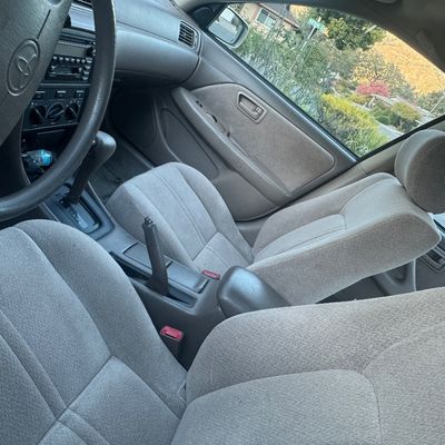 Sale Photo Thumbnail #107: Interior view of 2001 Toyota Camry LE featuring gray cloth seats, automatic transmission, and dashboard controls in clean condition.