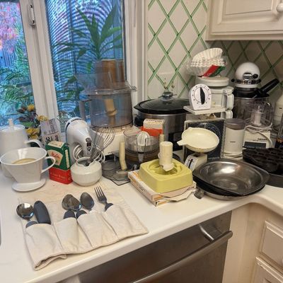 Sale Photo Thumbnail #26: Collection of vintage and modern kitchen small appliances and cookware, including food processors, a KitchenAid stand mixer, coffee makers, and a scale.