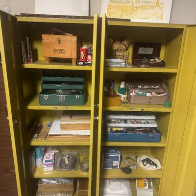 Sale Photo Thumbnail #71: Vintage mustard yellow metal double cabinet filled with various household supplies, toolboxes, art materials, and collectibles.