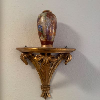 Sale Photo Thumbnail #18: Small Satsuma-style porcelain vase with floral motifs resting on a vintage gilt carved wood wall bracket shelf.