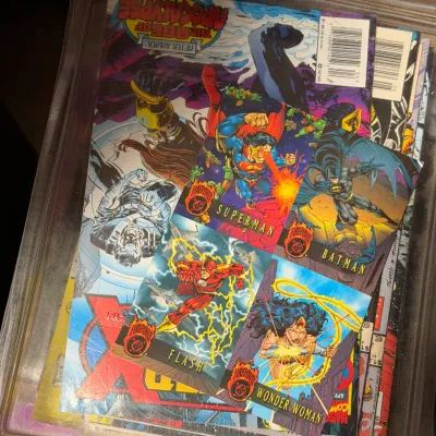 Sale Photo Thumbnail #15: Selection of 1990s comic books including X-Men: Age of Apocalypse and four DC Firepower trading cards featuring Superman, Batman, Flash, and Wonder Woman, stored in a clear plastic bin.