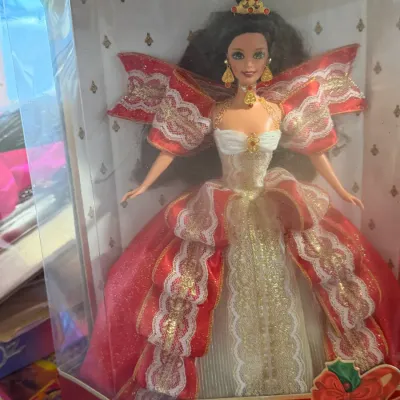 Sale Photo Thumbnail #11: 1993 Special Edition Happy Holidays Barbie doll featuring a brunette doll in a festive red and gold lace gown, unopened in its original packaging.