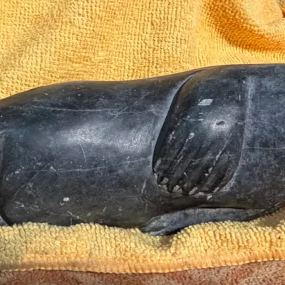 Sale Photo Thumbnail #3: Hand-carved dark gray soapstone seal sculpture, Inuit-style art piece with smooth polished finish.
