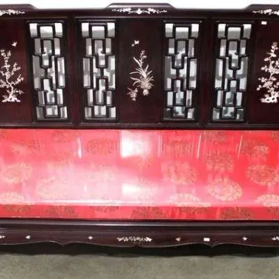 Sale Photo Thumbnail #28: Chinese carved rosewood bench sofa featuring mother-of-pearl inlays, intricate lattice back panels, and a fitted red brocade cushion.