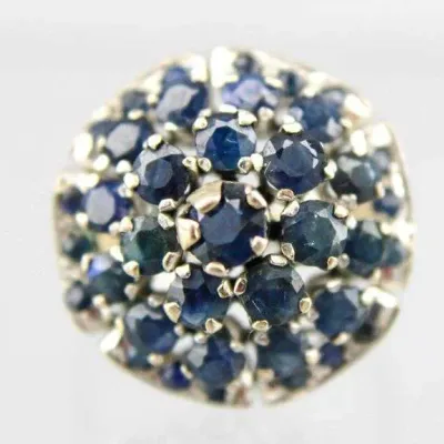 Sale Photo Thumbnail #2: Vintage white gold or platinum cluster ring set with round faceted blue sapphires in a domed flower pattern.