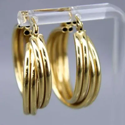 Sale Photo Thumbnail #27: Pair of gold-tone triple-strand hoop earrings displayed on a clear acrylic stand.