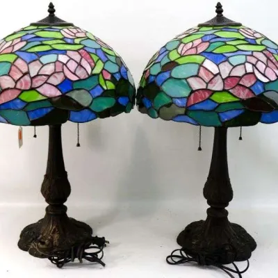 Sale Photo Thumbnail #22: Pair of Tiffany-style stained glass table lamps featuring a colorful floral pattern in pink, green, and blue on dark bronze-finished metal bases.