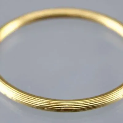 Sale Photo Thumbnail #8: Yellow gold hinged bangle bracelet featuring fine grooved texturing around the band and a box clasp closure.