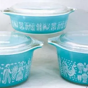 Sale Photo Thumbnail #18: Set of three vintage Pyrex turquoise 'Butterprint' pattern casserole dishes with clear glass lids.