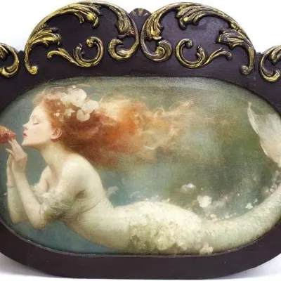 Sale Photo Thumbnail #23: Framed mythical art print depicting a red-haired mermaid interacting with a fish underwater. Encased in a dark wood, ornate crown-topped oval frame with gilded acanthus scroll accents.