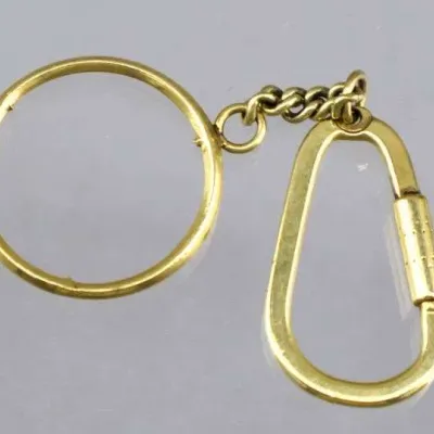 Sale Photo Thumbnail #3: Vintage brass keychain featuring a screw-lock carabiner clip and split key ring connected by a short chain.