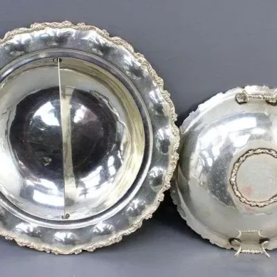 Sale Photo Thumbnail #21: Vintage silver-plated divided serving dish with a matching lid, featuring ornate scrolled rims and handles.