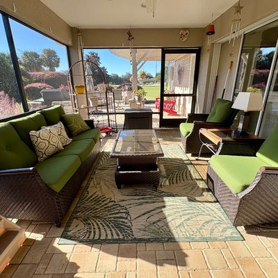 4-piece resin wicker outdoor patio set with a sofa, coffee table and 2 swivel gliders 