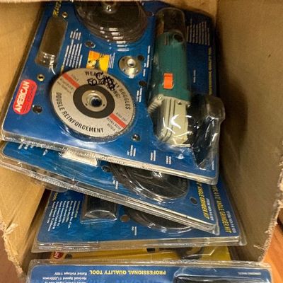 Sale Photo Thumbnail #20: Box containing multiple unused American Tool Exchange 4-1/2 inch angle grinder kits in original blister pack packaging.