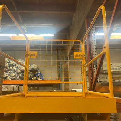 Sale Photo Thumbnail #8: Yellow industrial safety work platform with high guardrails and wire mesh back screen, designed for forklift attachment.