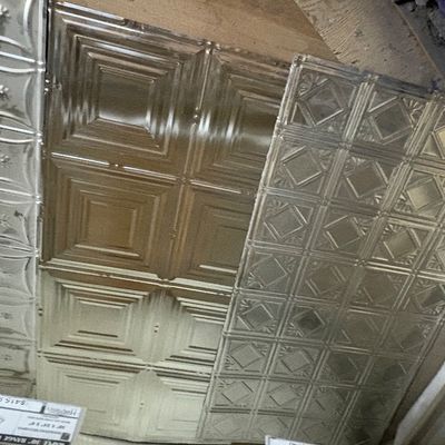 Sale Photo Thumbnail #34: Collection of decorative stamped metal tin ceiling tiles featuring various geometric and floral relief patterns.