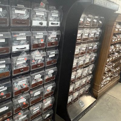 Sale Photo Thumbnail #68: Large Jeffrey Alexander retail display racks filled with labeled bins of cabinet hardware, knobs, and pulls.
